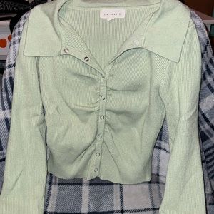 Green collared long sleeve shirt.